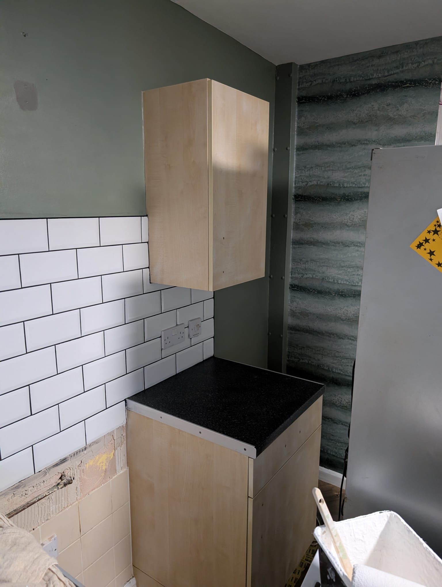 Kitchen with sage green painted walls and subway tiles