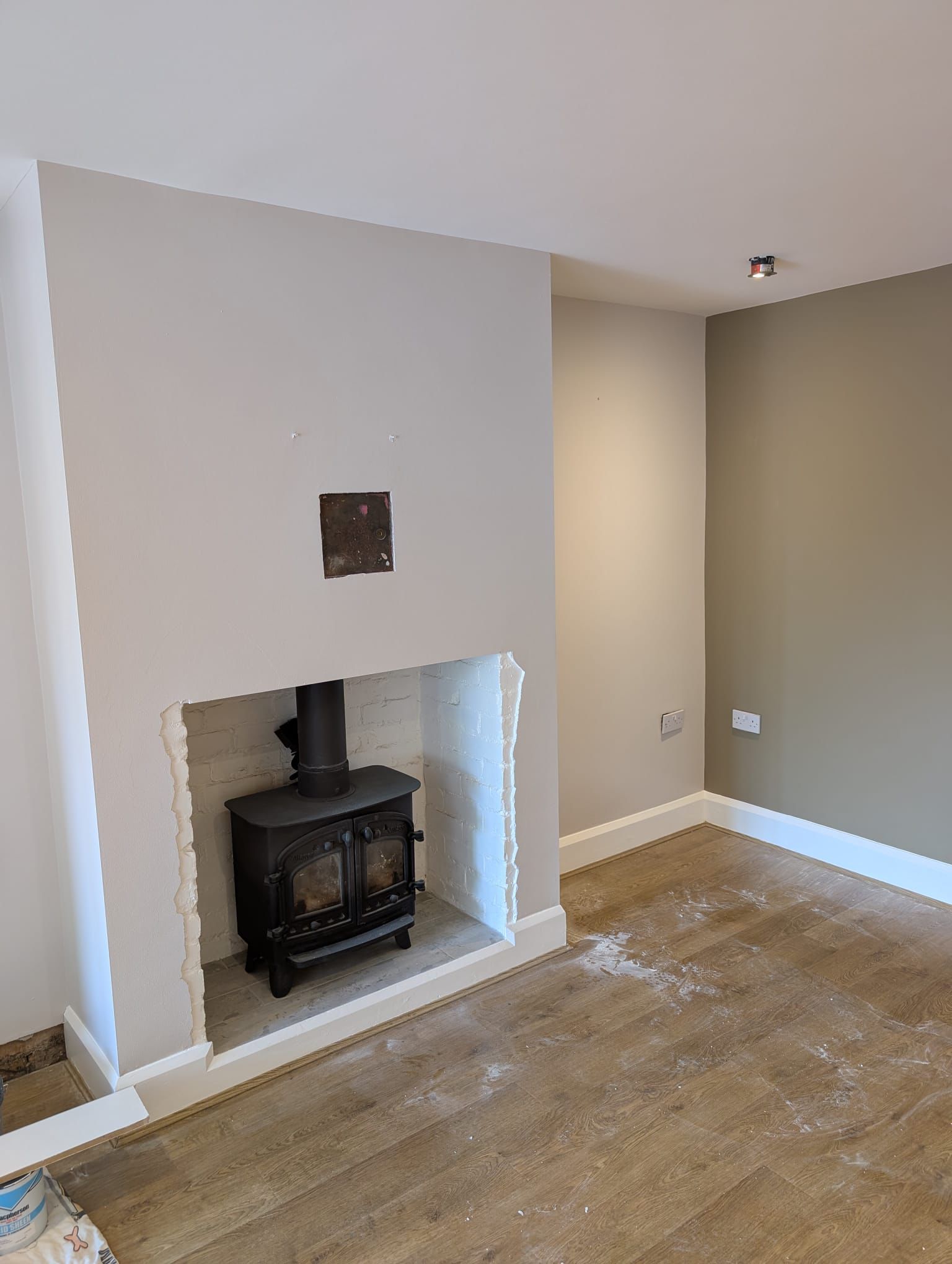 Living room with freshly painted feature wall and fireplace