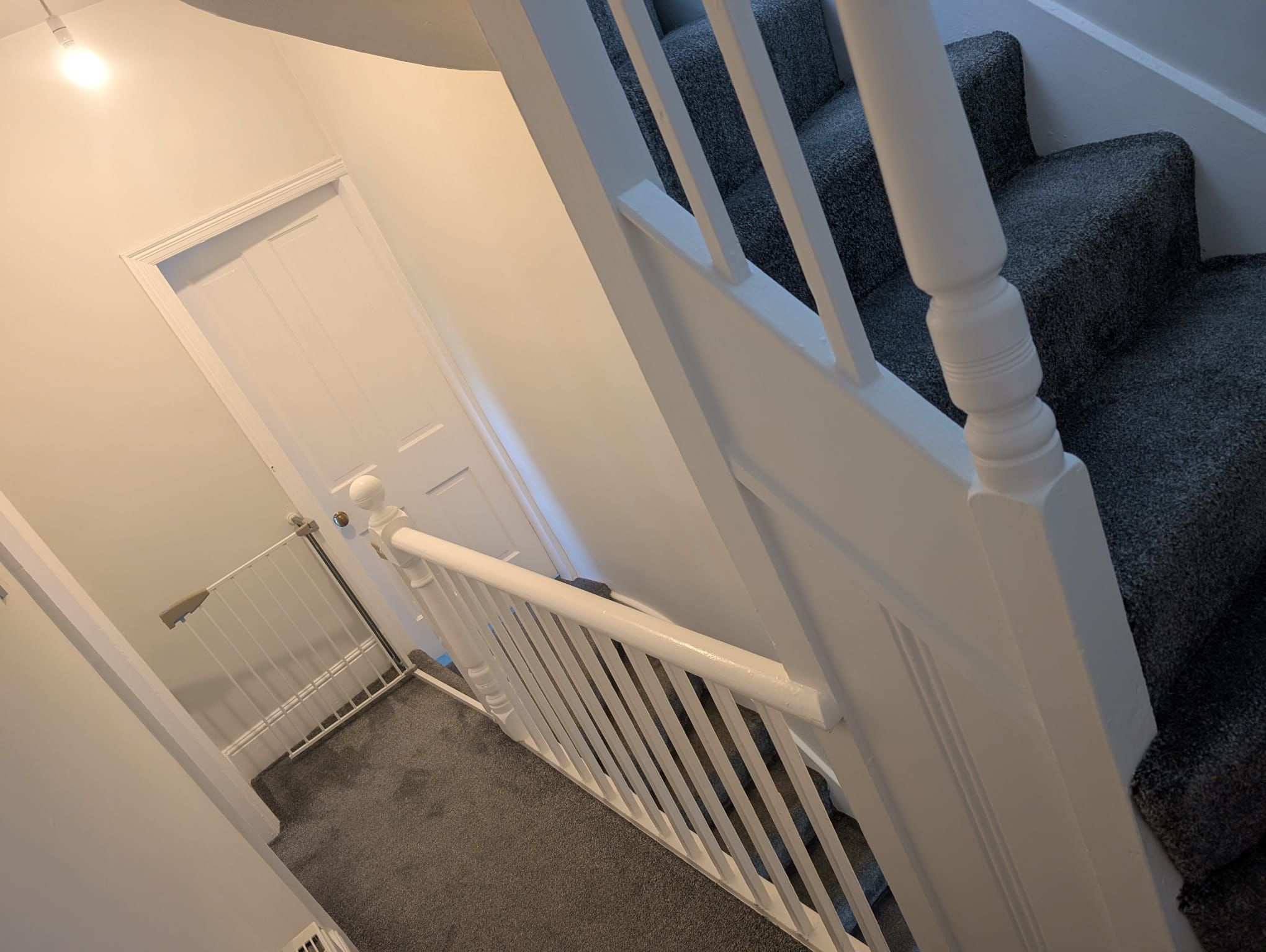 Staircase with freshly painted white gloss banister and railings